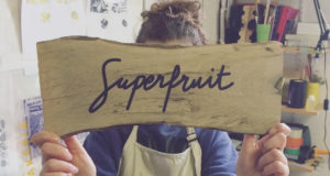 Photo du blog, impression en sérigraphie du logo Superfruit sur une planche de bois